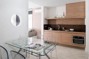 a dining room with a glass table and chairs at Eric Vökel Boutique Apartments - BCN Suites in Barcelona +23 photos