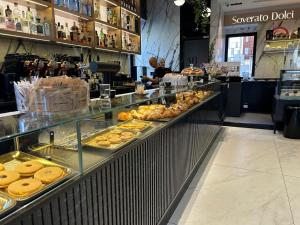 a bakery with a display case filled with lots of donuts at Blu Opèra Guest Rooms in Soverato Marina