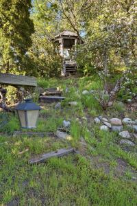 a garden with a bench and a light in the grass at Anthony's Home in Spokane