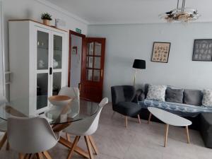a living room with a glass table and chairs at Cute Home Bethlem in Cuenca