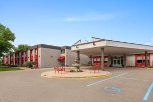 a building with a parking lot in front of it at Ramada by Wyndham Grand Forks in Grand Forks