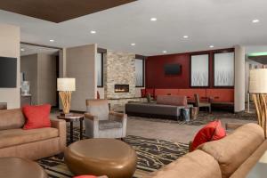 a living room with couches and a fireplace at Ramada by Wyndham Grand Forks in Grand Forks