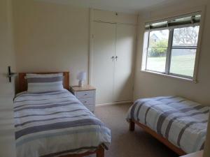 a bedroom with two beds and a window in it at Beach Break in Tathra