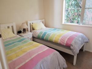 a bedroom with two beds and a window at Beach Break in Tathra +3 photos