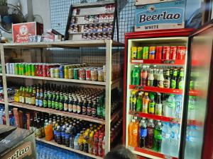 a refrigerator filled with lots of different types of drinks at Khamphouy Guesthouse in Champasak
