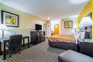 a hotel room with a bed and a desk at Quality Inn Carbondale University area in Carbondale