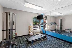 a gym with two tread machines and a mirror at Quality Inn Rochester South in Rochester