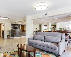 a living room with a couch and a table at Quality Inn Mt Pleasant - Charleston in Charleston
