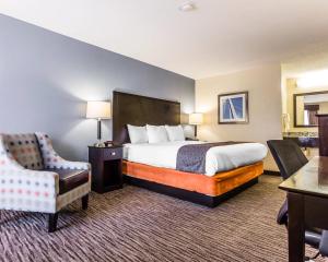 a hotel room with a bed and a chair at Quality Inn Mt Pleasant - Charleston in Charleston +24 photos