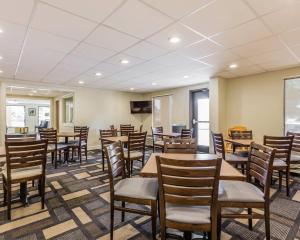 a dining room with wooden tables and chairs at Quality Inn Mt Pleasant - Charleston in Charleston
