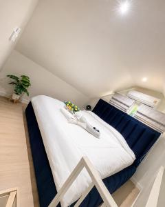 a bedroom with a large white bed with blue sheets at Norden Barn B&B in Chiang Mai +213 photos
