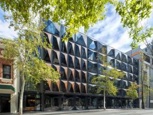 an office building with a lot of windows at West Hotel Sydney, Curio Collection by Hilton in Sydney