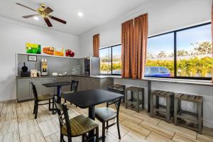 a dining room with a table and chairs and windows at Quality Inn near Blue Spring in Orange City