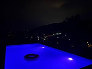 a blue pool table with a view at night at Vikendica Dajana in Banja Luka
