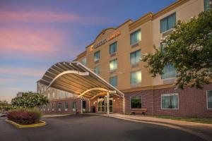 a rendering of a hotel with an arch entrance at Comfort Suites Manassas Battlefield Park in Manassas