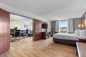 a hotel room with a bed and a desk at Comfort Suites Manassas Battlefield Park in Manassas