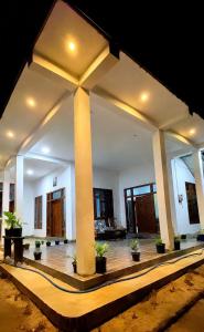 a lobby with potted plants in a building at ZEN House Arugambay in Arugam Bay