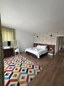 a bedroom with a bed and a colorful rug at Villa Nature in Sarajevo +12 photos