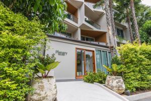 a building with plants in front of it at Wyndham Grand Nai Harn Beach Phuket in Nai Harn Beach