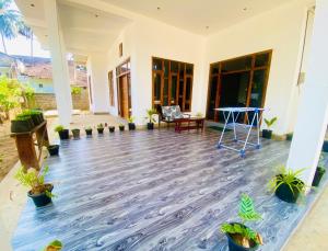 a patio with plants on the floor of a house at ZEN House Arugambay in Arugam Bay