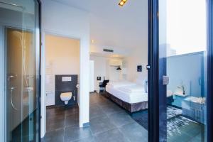 a bedroom with a bed and a bathroom at LINDEMANN'S in Berlin