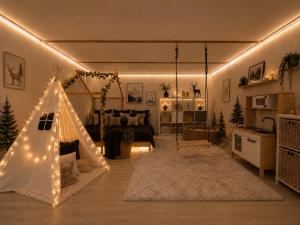 a living room with a tent with lights in it at Chata Malenovice in Malenovice
