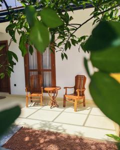 two chairs and a table in a room at Mogra Bliss in Matara +108 photos