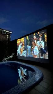 a television screen with a group of people playing instruments at Green house eco hotel Samarkand in Samarkand
