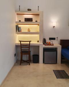 a room with a desk and a chair in a room at Mogra Bliss in Matara