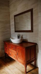 a bathroom with a sink on a wooden dresser with a mirror at De Mist Graskop in Graskop +19 photos