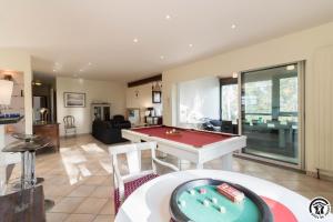 a living room with a pool table in it at La maison imart in Revel