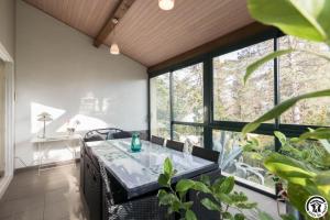 a dining room with a table and large windows at La maison imart in Revel +40 photos