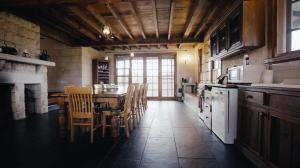 a kitchen with a table and chairs in a room at Hank's Folly in Wapengo