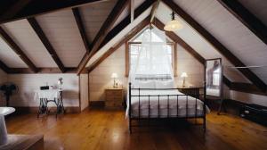a bedroom with a bed and a window in a attic at Hank's Folly in Wapengo