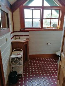 a bathroom with a sink and a window at Hank's Folly in Wapengo