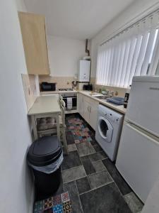 a kitchen with a sink and a washer and dryer at Pet-Friendly Home with Secure Garden nr Beamish in Birtley