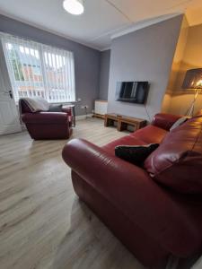a living room with a couch and a television at Pet-Friendly Home with Secure Garden nr Beamish in Birtley