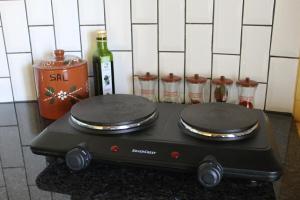 a stove in a kitchen with a bottle of wine at Penacova Moinho do Ligeiro near Coimbra in Penacova