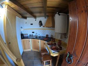a small kitchen with a sink and a table at Penacova Moinho do Ligeiro near Coimbra in Penacova