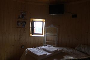 a bedroom with a bed and a window at Penacova Moinho do Ligeiro near Coimbra in Penacova