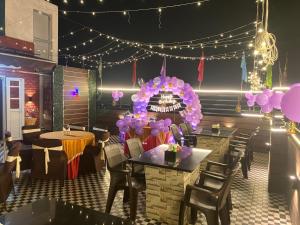 a restaurant with tables and chairs and a chandelier at The Pride in Jamshedpur