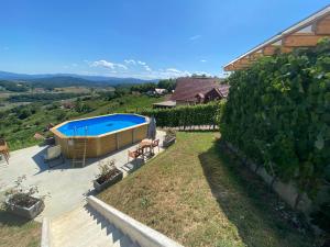 a house with a swimming pool in a yard at Vineyard Cottage Joanna in Mirna Peč