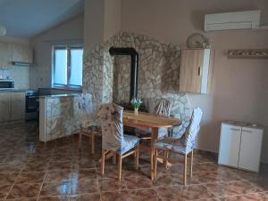 a kitchen and dining room with a table and chairs at Apartment Alina in Umag
