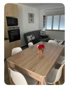 a wooden table in a living room with a couch at Chez Melanie in Neuilly-le-Réal