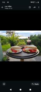 two plates of food sitting on a table at Rowan retreat,Renwick, Penrith,CA10 1LA in Penrith