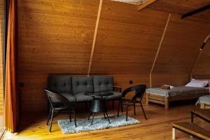 a room with a couch and chairs and a table at Machakhela Peaks in Sindietʼi
