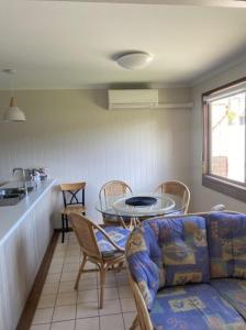 a living room with a couch and a table at Edna's Retreat in Tathra