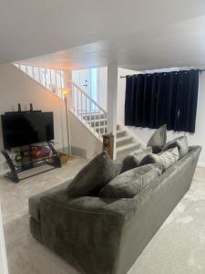 a living room with a couch and a tv at Anthony's Home in Spokane