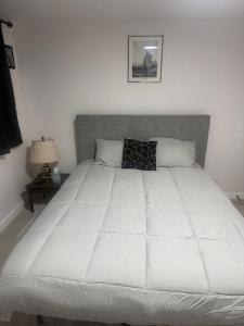 a large white bed in a bedroom with a lamp at Anthony's Home in Spokane