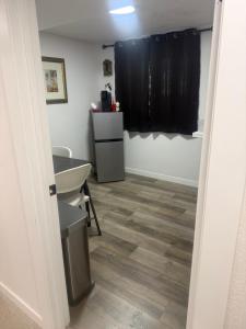 a bathroom with a sink and a refrigerator at Anthony's Home in Spokane